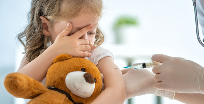 Young girl getting a vaccine.